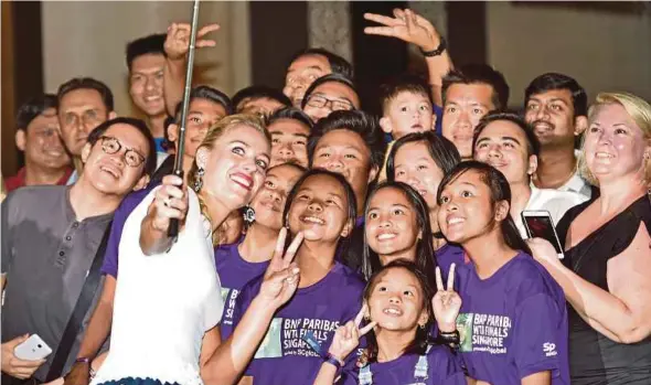  ??  ?? Angelique Kerber takes a wefie with fans
AFP pic