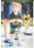  ?? PHOTOS: ASHLEY FRaSER ?? Left: Two-year-old Brady Haley plays in the water park during the Family Pride Picnic.
