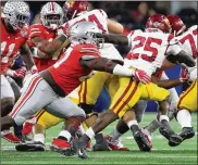  ?? DAVID JABLONSKI / STAFF ?? Ohio State’s Robert Landers, tackling USC’s Ronald Jones II in the Cotton Bowl in December, was credited with five tackles for loss last season.