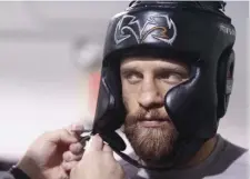  ?? PauL CONNORS / BOStON HERaLd FiLE ?? LOCAL LEGEND: Calvin Kattar, a Methuen native, has head gear strapped on by trainer Tyson Chartier as he prepares to spar at Lauzon’s Gym in Easton in 2019.