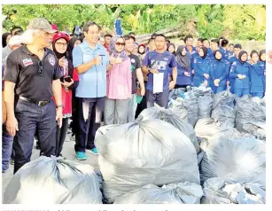  ??  ?? KAMARUDIN (tiga kiri) mengambil gambar kenangan bersama peserta gotong royong. Turut kelihatan Rossita (empat kiri).