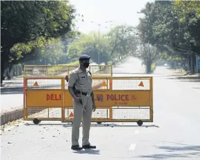  ?? AFP ?? A policeman stands guard in New Delhi yesterday, the day after Indian Prime Minister Narendra Modi announced a 21-day nationwide lockdown as a preventive measure against Covid-19.