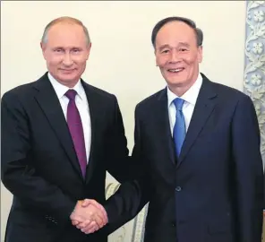  ?? YAO DAWEI / XINHUA ?? Russian President Vladimir Putin meets Vice-President Wang Qishan in St. Petersburg, Russia, on Thursday.