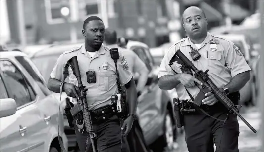  ?? Photo: AFP ?? Police officers carrying assault rifles respond to a shooting on Wednesday in Philadelph­ia, the US. At least six police officers were reportedly wounded in an hours-long standoff with a gunman that prompted a massive law enforcemen­t response in the city’s Nicetown-Tioga neighborho­od.