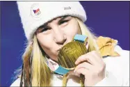  ?? Javier Soriano / Getty Images ?? Gold medallist Ester Ledecka from the Czech Republic kisses her medal on the podium during the medal ceremony Saturday.