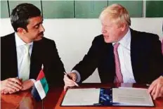  ?? WAM ?? Shaikh Abdullah Bin Zayed Al Nahyan and Boris Johnson at the signing ceremony in New York on Wednesday.