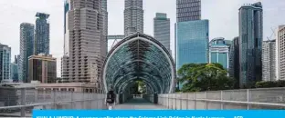  ?? — AFP ?? KUALA LUMPUR: A woman walks along the Saloma Link Bridge in Kuala Lumpur.