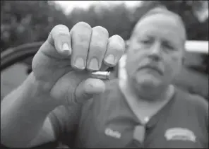  ?? Arkansas Democrat-Gazette/STEPHEN B. THORNTON ?? Chris Finley keeps a shell casing he found after Jonesboro police shot and killed his mentally-ill son Grant Finley. An officer fired 14 times through the door of Grant Finley’s home after Finley pushed a machete through a space between the broken door...