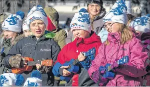  ?? CP PHOTO ?? School children sing seasonal songs at the cutting of a Christmas tree in Oxford, Cumberland County on Thursday. Area residents Ross McKellar and Teresa Simpson donated the 14-metre white spruce. Each year, Nova Scotia sends a tree to Boston to thank the city for sending medical personnel and supplies when nearly 2,000 people were killed in the Halifax Explosion. Hundreds more were left injured or homeless by the 1917 disaster.