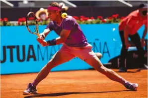  ?? The Associated Press ?? ■ Spain’s Rafael Nadal returns the ball to Australia’s Alexei Popyrin during their Thursday match at the Mutua Madrid Open in Madrid, Spain.