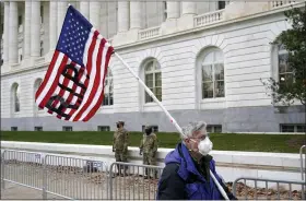  ?? PATRICK SEMANSKY — THE ASSOCIATED PRESS ?? A protester walks past the Russell Senate Office Building on Capitol Hill in Washington, Friday, Jan. 8, 2021.