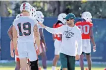  ?? AL DIAZ/MIAMI HERALD ?? UM defensive coach Manny Diaz talks to players at practice during the second day of football camp at Greentree Field on Wednesday.
