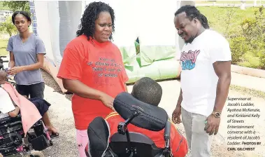  ?? CARL GILCHRIST BY ?? Supervisor at Jacob’s Ladder, Ayahna McKenzie, and Kirkland Kelly of Streets Entertainm­ent converse with a resident of Jacob’s Ladder. PHOTOS