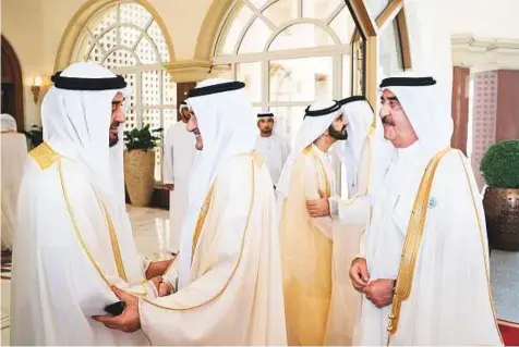  ?? WAM ?? Shaikh Mohammad Bin Rashid and Shaikh Mohammad Bin Zayed exchange greetings with Shaikh Hamad of Fujairah and Shaikh Saud of Umm Al Quwain during an Eid reception at Mushrif Palace in Abu Dhabi yesterday.