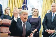  ?? [AP PHOTO] ?? President Donald Trump answers a reporter’s question about the investigat­ion of special counsel Robert Mueller during a signing ceremony of the “Cybersecur­ity and Infrastruc­ture Security Agency Act” in the Oval Office of the White House on Friday in Washington.