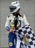  ?? Chris Graythen/Getty Images ?? Chase Elliott celebrates with the checkered flag after winning the Go Bowling 235 Sunday at Daytona Internatio­nal Speedway in Daytona Beach, Fla.