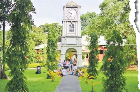  ?? Picture: JOVESA NAISUA ?? Tourists gather around the landmark clock at the Suva Botanical Gardens just outside the Fiji Museum.