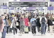  ?? MIGUEL MARTINEZ The Atlanta Journal-Constituti­on/TNS ?? Passengers navigate through Terminal B at Hartsfield-Jackson Atlanta Internatio­nal Airport on March 11. In its efforts to accommodat­e the growing demand for travel, the airport is in the midst of a multibilli­on-dollar expansion,