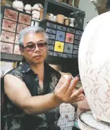  ??  ?? Changwan Hong working on a pot; top, ceramic artist Changho Ahn