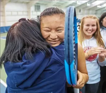  ?? Steph Chambers/Post-Gazette photos ?? Peters Township’s Kat Wang receives a hug from her mother Thursday after beating Fox Chapel’s Carissa Shepard to help the Indians win the WPIAL 3A team championsh­ip at Alpha Tennis Center in Harmar.