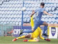  ??  ?? ●●Matty Warburton hits the back of the net