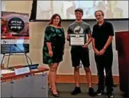  ?? DAN SOKIL - DIGITAL FIRST MEDIA ?? ‘Backyard Beans’ owner Matt Adams, center, receives the borough’s Business of the Month award from Economic Developmen­t Committee members Bruce Schwartz, right, and Carrie Hawkins Charlton during the borough council meeting on July 18, 2018.