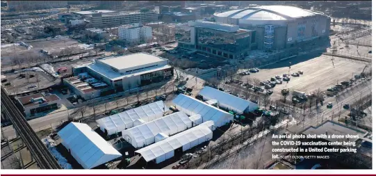  ?? SCOTT OLSON/GETTY IMAGES ?? An aerial photo shot with a drone shows the COVID-19 vaccinatio­n center being constructe­d in a United Center parking lot.