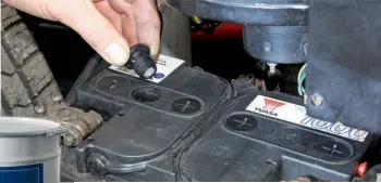  ??  ?? ABOVE: If the fluid levels inside the battery can be checked, top them up with distilled water. INSET: Petroleum jelly can be spread over the battery terminals to help prevent corrosion.