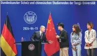  ?? MICHAEL KAPPELER / AP ?? German Chancellor Olaf Scholz attends an exchange event with students at Tongji University in Shanghai on Monday.