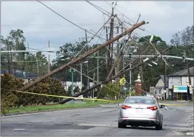  ?? STEVE HELBER—ASSOCIATED PRESS ?? Traffic diverts around downed power lines Monday, Aug. 30, 2021, in Metairie, La. A fearsome Hurricane Ida has left scores of coastal Louisiana residents trapped by floodwater­s and pleading to be rescued, while making a shambles of the electrical grid across a wide swath of the state in the sweltering, late-summer heat. One of the most powerful hurricanes ever to hit the U.S. mainland has now weakened into a tropical storm as it pushes inland over Mississipp­i with torrential rain and shrieking winds.