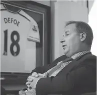  ?? TYLER ANDERSON NATIONAL POST ?? Top, a fan awaits the start of a Real Madrid match. The football club has a unique corporate structure that some argue adds to its global appeal. Above, Dave Hopkinson, the former COO of MLSE, has been drafted by Real Madrid as global head of partnershi­ps to market the Spanish team abroad.