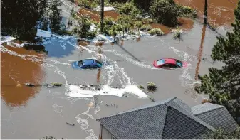  ?? Brett Coomer / Staff photograph­er ?? A home and some cars sit submerged by floodwater­s of Hurricane Harvey on Sept. 1, 2017, near Vidor. Several studies attribute the storm’s torrential rain at least partly to climate change.