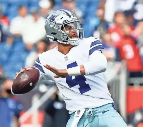  ?? BRIAN FLUHARTY/USA TODAY SPORTS ?? Cowboys quarterbac­k Dak Prescott throws during warmups before a game against the New England Patriots on Oct. 17.