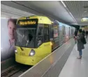  ?? ?? A Manchester Metrolink tram bound for Bury. Under Rossendale Council’s current plan, commuters from Rawtenstal­l would take a Vivarail Class 230 DMU to a new interchang­e station at Buckley Wells, and then board a Metrolink tram to Manchester city centre. Would commuters be prepared to face the hassle of changing trains each way every day, or prefer to make one single journey using a car or bus? ROBIN JONES