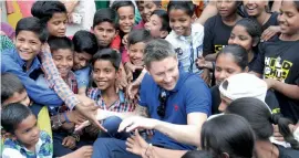  ?? — G.N. JHA ?? Former Australian cricket captain Michael Clarke interacts with slum children in New Delhi on Friday.