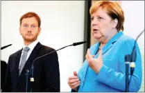  ?? PICTURE: REUTERS ?? German Chancellor Angela Merkel, next to Minister President of Saxony Michael Kretschmer, at a news conference after visiting the state parliament in Dresden.