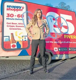  ??  ?? Ashley Blake, head of marketing at Snappy Shopper, in front of the advertisin­g trailers.