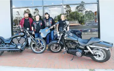  ??  ?? Partisans Australia MMC members Benji Longson, Robin May, Sean Scanlon and Zanzii Bowers prepare for this weekend’s VetRok event at Longwarry. Sean is holding a signed Lee Kernaghan guitar that will be auctioned to raise funds.