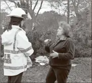  ?? Doug Walker ?? Rome Fire Marshal Mary Catherine Chewning (left) speaks with Sherry Williams, a friend of the owner of a home at 50 Biddy Road which was gutted by fire Thursday night and Friday morning.