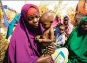  ?? Farah Abdi Warsameh Associated Press ?? FAMILIES at a camp in Somalia, where “millions are teetering on the edge of hunger and catastroph­e.”