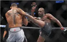  ?? ERIC JAMISON — THE ASSOCIATED PRESS ?? Jon Jones, right, lands a kick on Thiago Santos during their light heavyweigh­t bout at UFC 239on July 6, 2019, in Las Vegas.