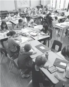  ?? JASON KRYK ?? Enrolment growth has occurred across the public system’s 55 elementary schools. Above, a Grade 5-6 split class gets down to work at Marlboroug­h Public School in Windsor Tuesday.