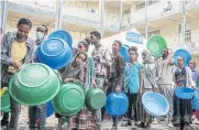  ?? AFP ?? People who fled violence in Ethiopia’s Tigray region wait to receive food in this June 2021 file photo at a camp, in Mekele, the capital of Tigray region.