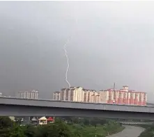  ??  ?? Surge of energy: A lightning strike during heavy rain in Kajang.