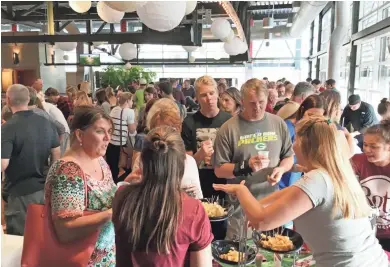  ?? MILWAUKEE PUBLIC MARKET ?? A crowd samples cheese at the 2016 Moo & Brew at the Milwaukee Public Market. The sampling of cheese, ice cream and beer returns Thursday, with proceeds from the $20 admission fee going to Hunger Task Force.