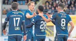  ??  ?? Dundee celebrate Kane Hemmings’ early goal at Cappielow.