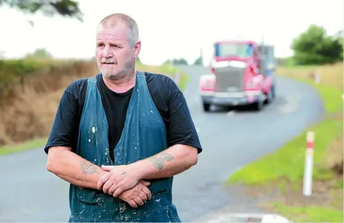  ?? PHOTOS: MARK TAYLOR/STUFF ?? Billy Rottier is concerned for the safety of people due to the trucks on Old School Road in Ngahinapou­ri. One is seen crossing the centreline behind him.