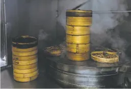  ??  ?? Barbecue pork buns are cooked in bamboo steamers at Hang Ah. The restaurant still uses the original 100yearold recipe.