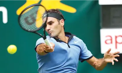  ??  ?? Switzerlan­d’s Roger Federer returns the ball during the ATP Tennis matach against Japan’s Yuichi Sugita in Halle, eastern Germany on June 20, 2017. - AFP photo