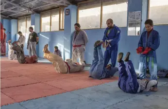  ??  ?? A morning sambo class run by Ashraf Taqdeer, the national coach. A highly respected instructor, Taqdeer’s classes are open to Afghans of all ages, background­s and skill levels